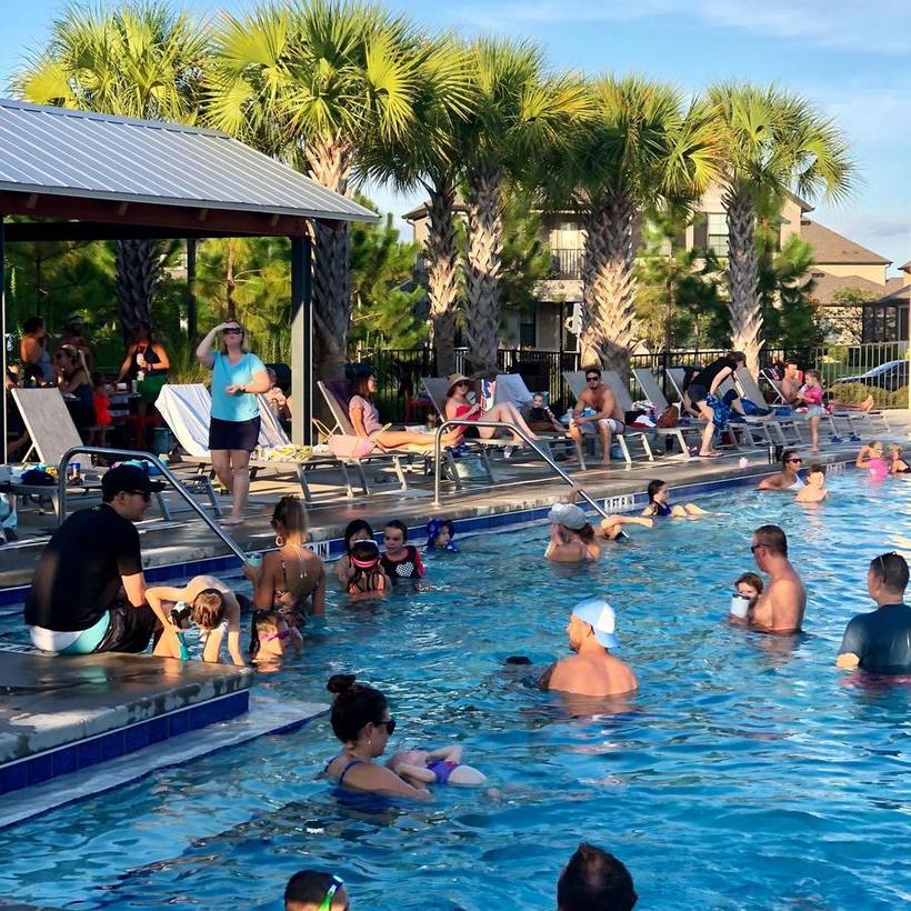 Residents and children gathered at the Starkey Ranch community pool on a sunny afternoon.